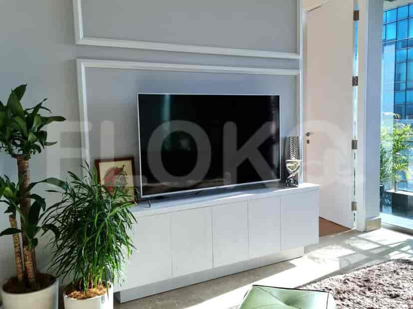 Living room with a TV and plants.