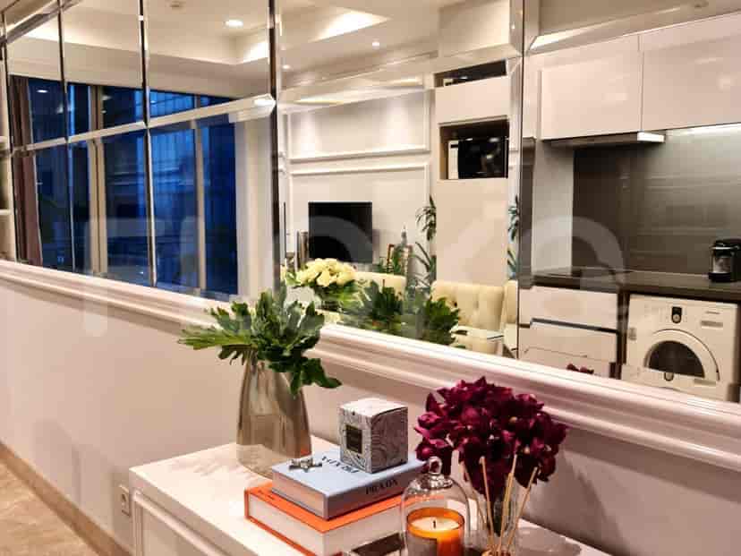 Elegant hallway with mirror and decorations.