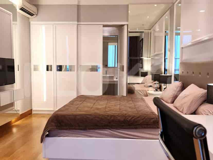 A modern bedroom with a king-size bed and wardrobe.