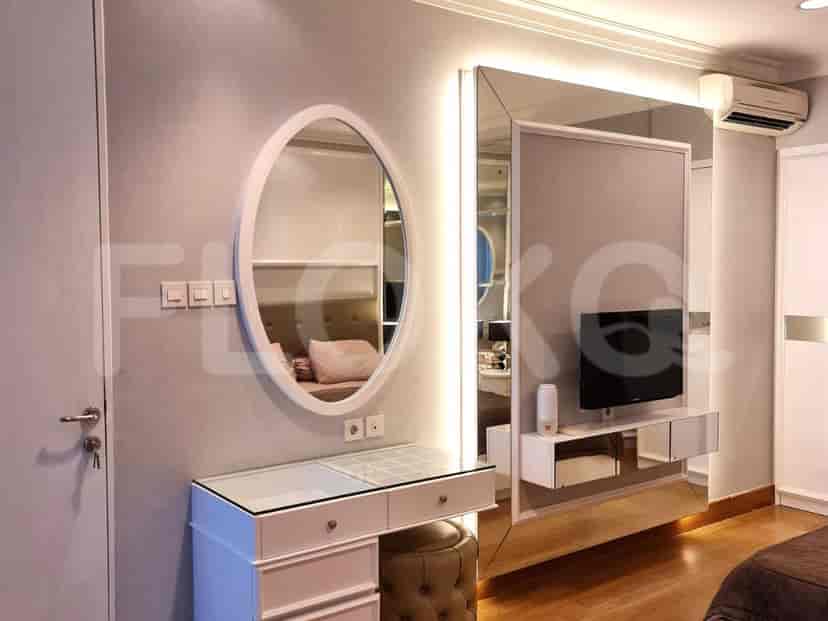Vanity with a mirror and TV.