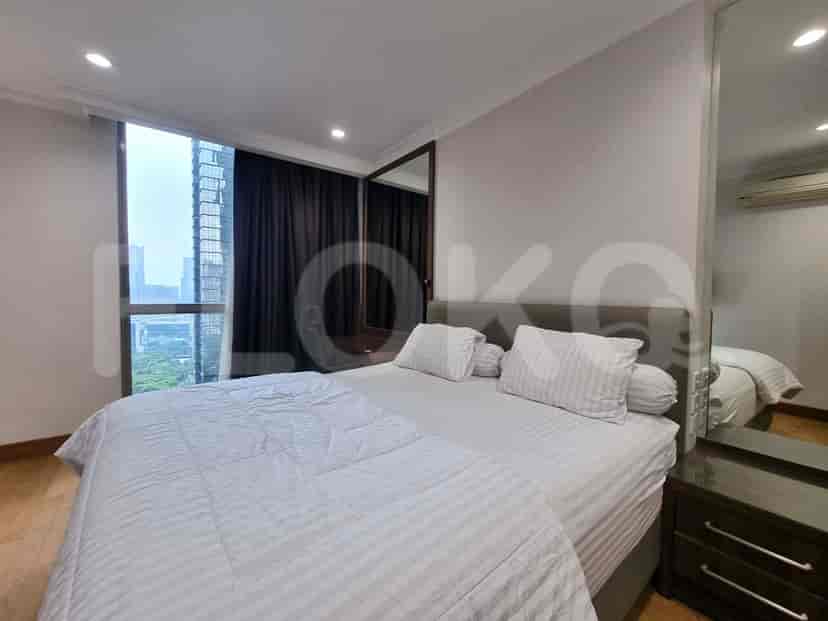 A bedroom with a large window, a comfortable bed, and a stylish design.