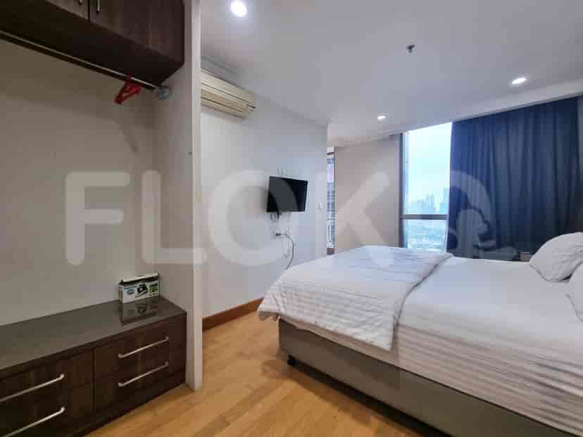 Bedroom with a bed, TV and closet.