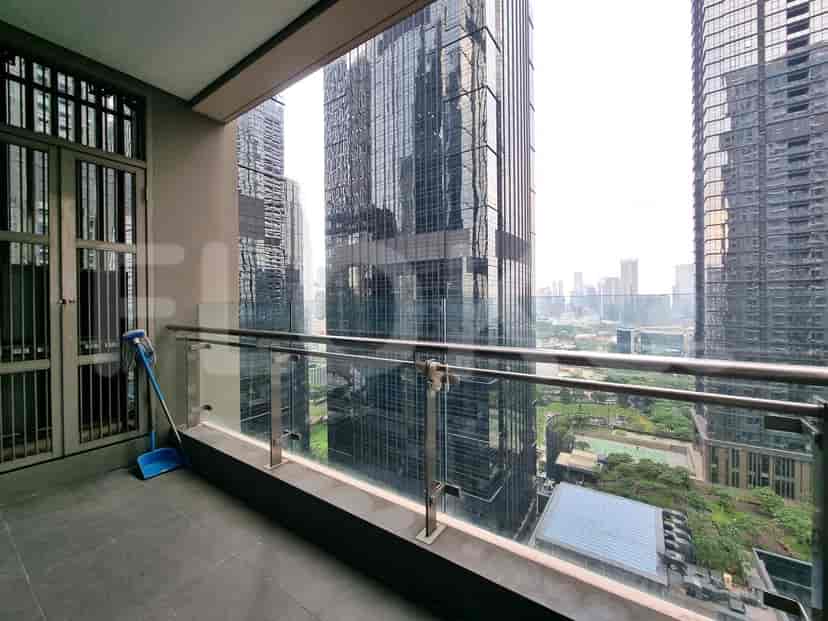 Balcony with glass railings and an urban view.