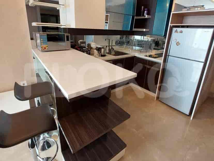 Modern kitchen with a breakfast bar, stainless steel appliances, and dark cabinets.