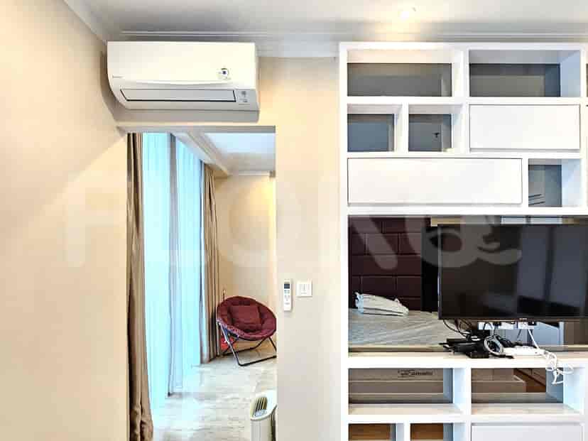 An entryway and a peek into the bedroom.