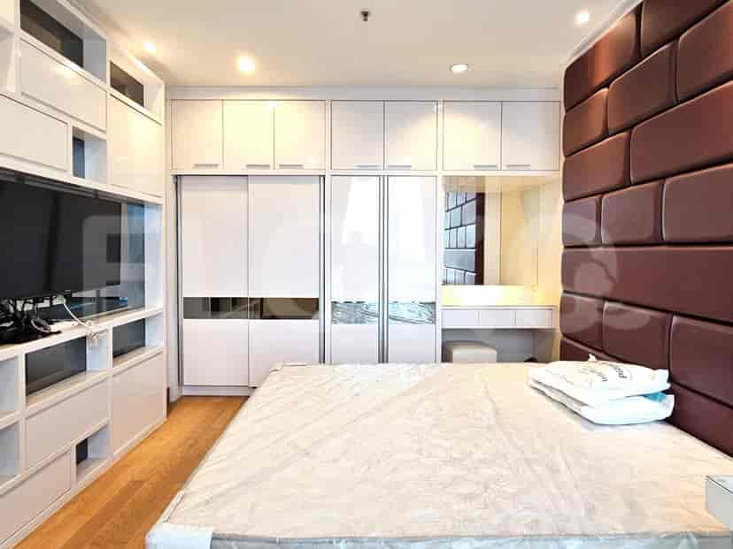 Modern bedroom with a large bed and a walk-in closet.