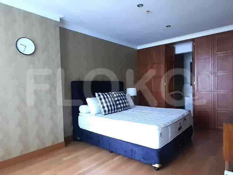Bedroom with a bed, closet, and clock.