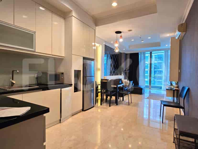An open-plan kitchen with a dining area, featuring modern appliances and sleek design.