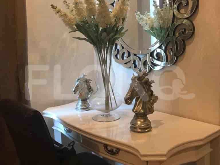 Entryway with a console table, mirror and decorative elements.