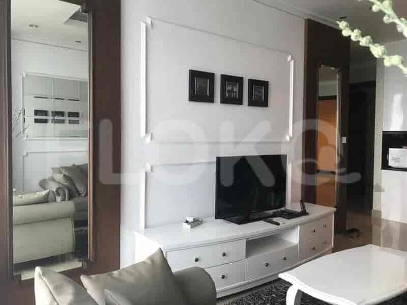 Living room with TV, sofa, and framed art.