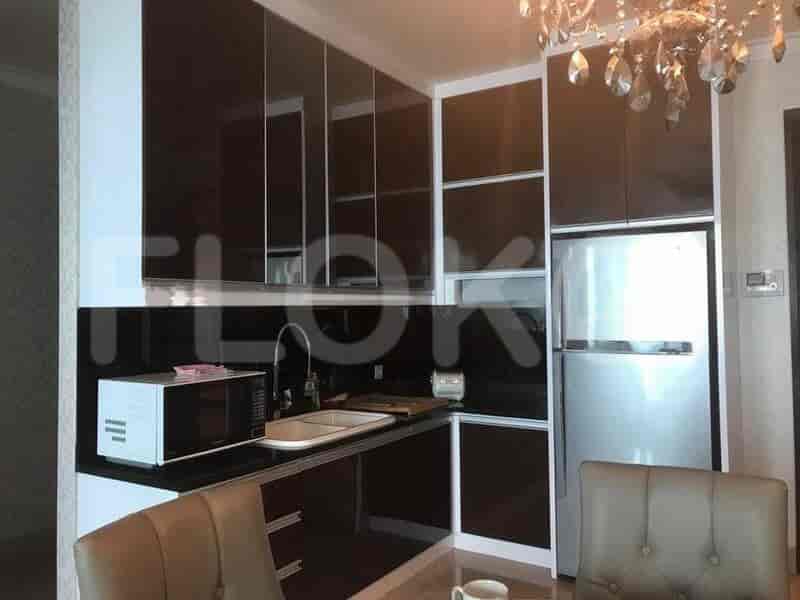 Modern kitchen with dark cabinets, appliances, and breakfast bar.