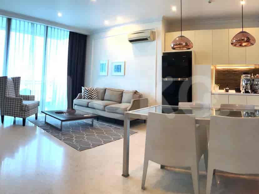 Spacious living area with a sofa, dining area, and modern kitchen.