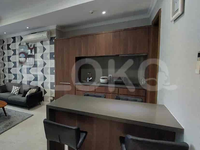 An open kitchen with bar seating next to a living area.