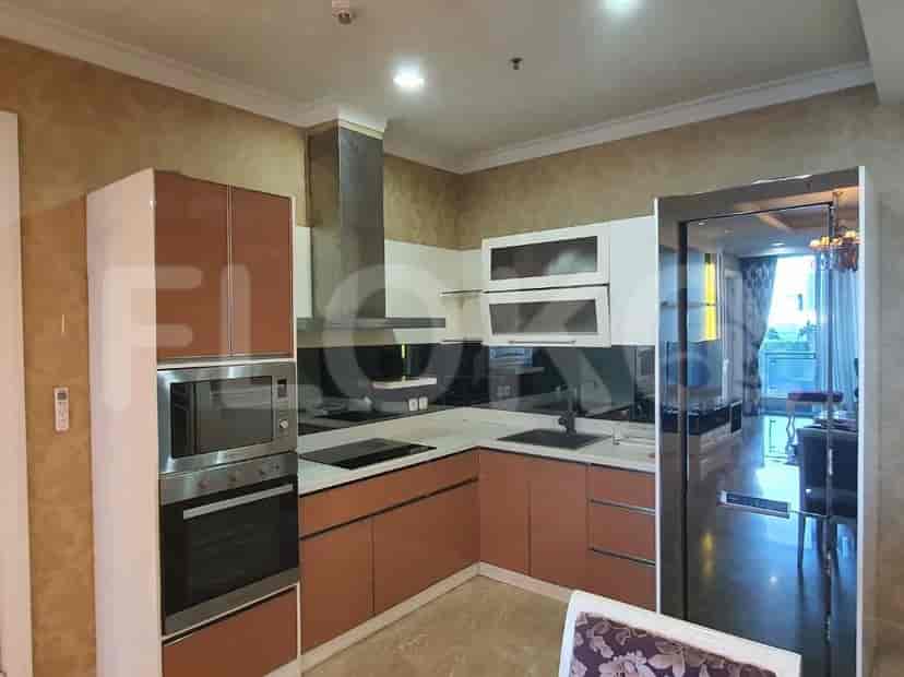 A modern kitchen with wooden cabinets, stainless steel appliances, and a countertop.