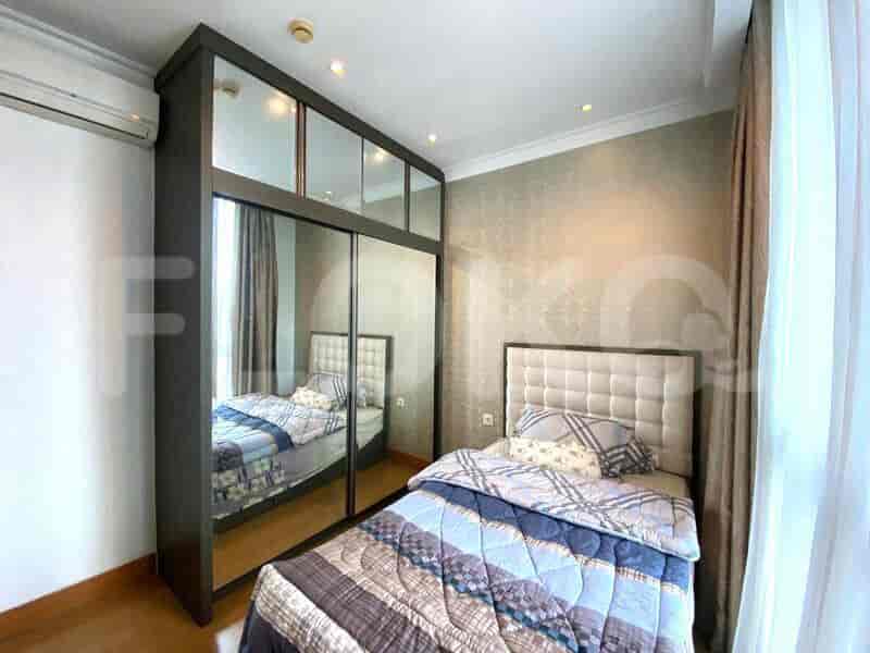 Bedroom with mirrored wardrobe, double bed, and wallpapered wall.
