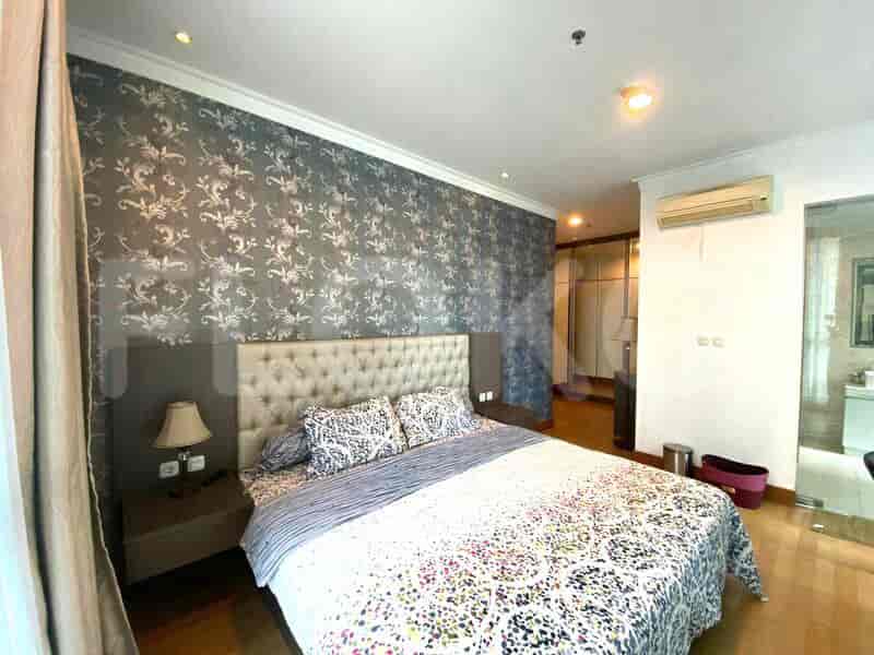 Master bedroom with a king-sized bed, wallpapered accent wall, and city views.