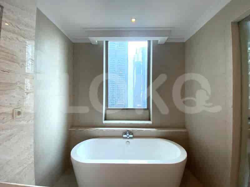 Modern bathroom with a walk-in shower, toilet, and vanity.