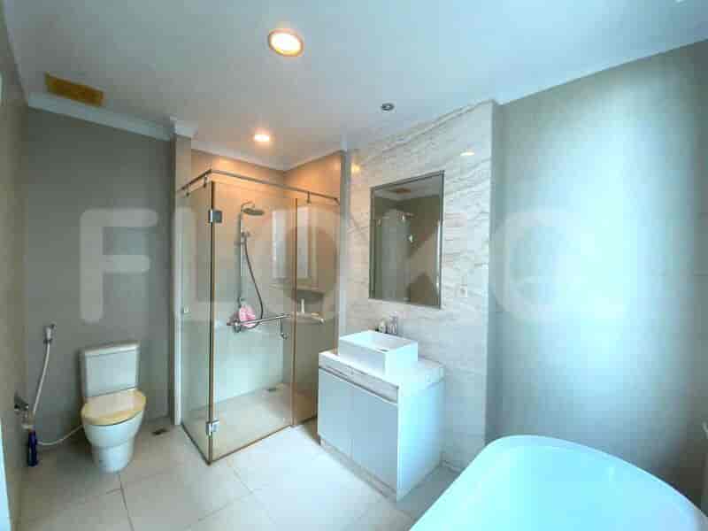 Modern bathroom with a walk-in shower, toilet, and vanity.