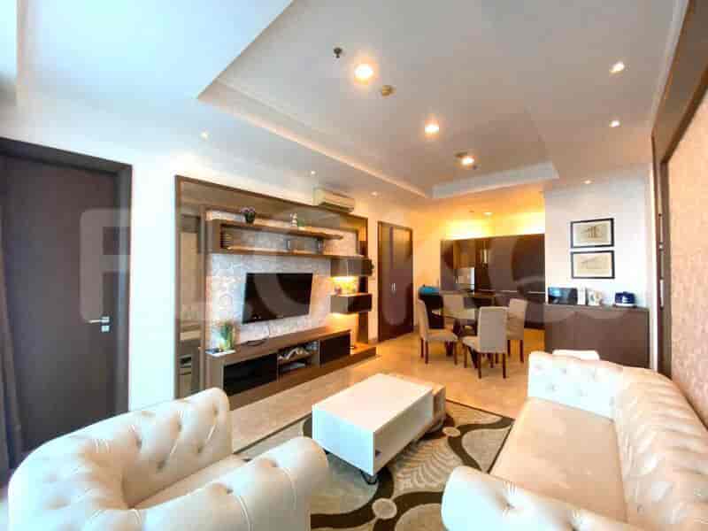 Luxurious living room with cream leather sofas, white coffee table, and built-in media center.