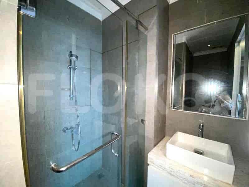 A bathroom with squat toilet and a shower.