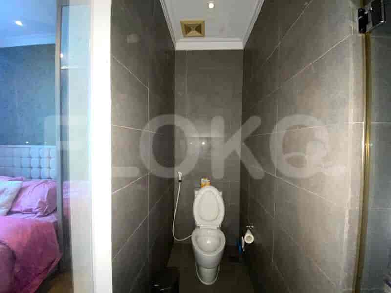 Hallway adjacent to the bedroom with white walls and tiled floors.