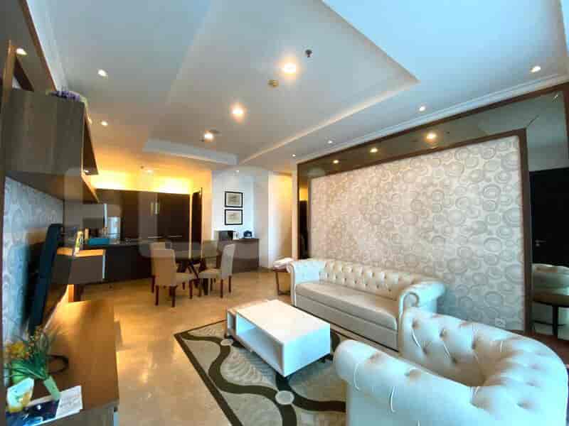 Living room featuring sofa, round dining table, and kitchen area.