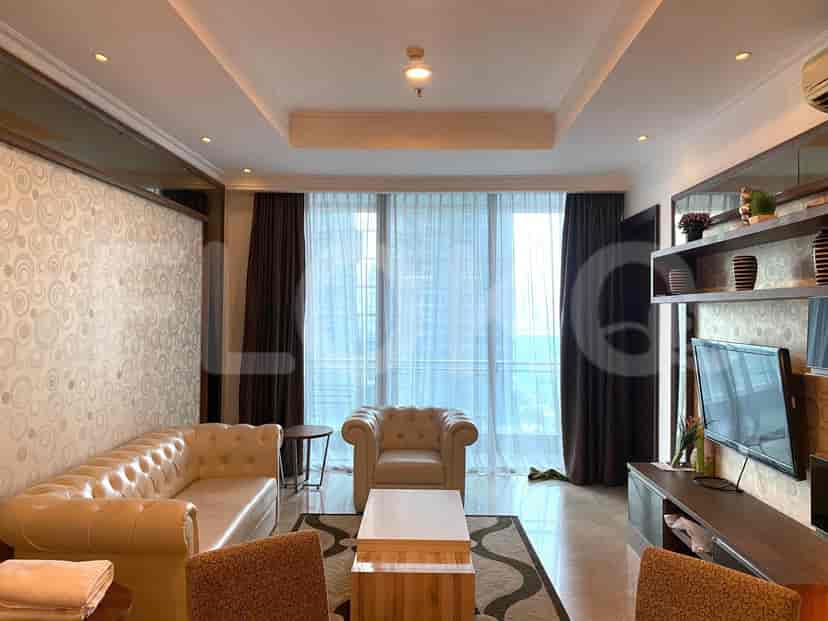 Living room with sofa, built-in TV unit, and views from the window.