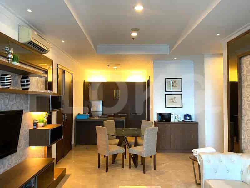 Modern kitchen with dark wood cabinets and a round dining table for four.