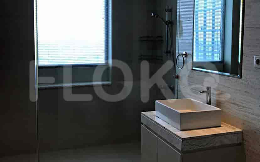 Modern bathroom featuring a shower, sink, and tiled walls.