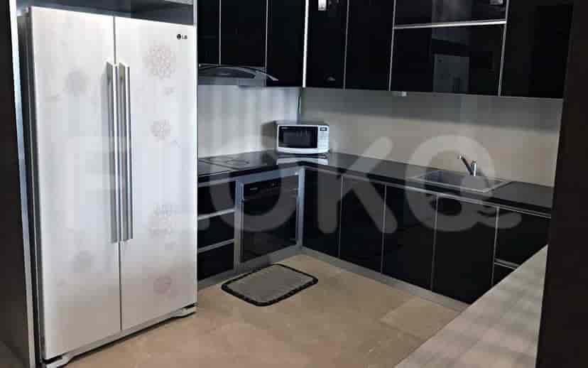 Modern kitchen with black cabinets, white appliances, and a functional layout.