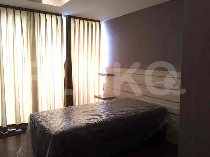 Another view of the bedroom with a bed covered in plastic and a minimalistic design.