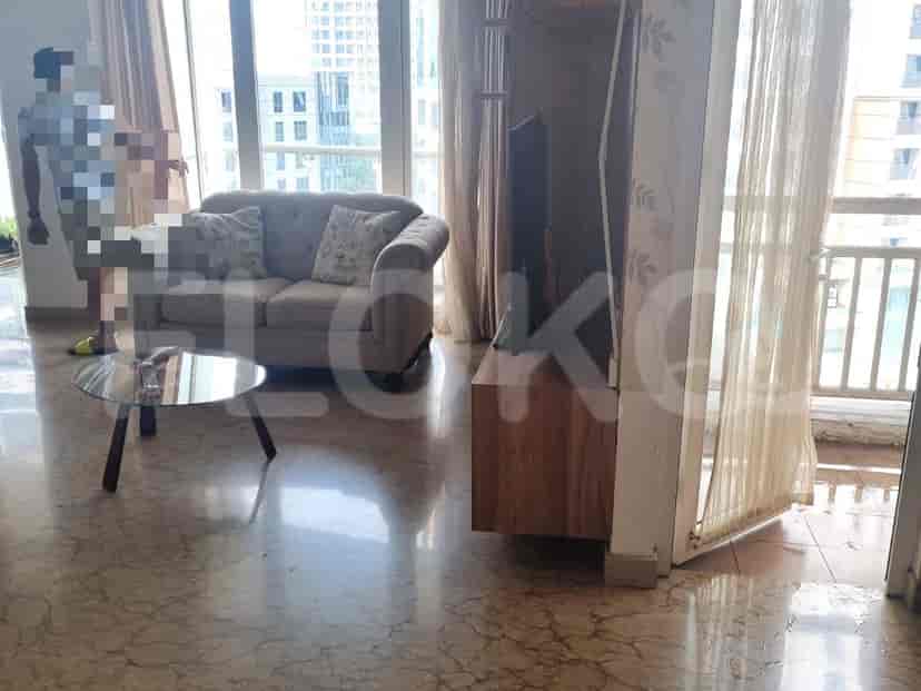 Living room with a sofa, coffee table, and city view.