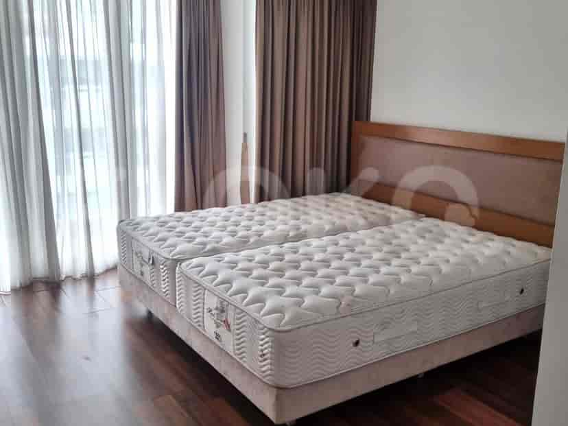Bedroom with a double bed, curtains, and wooden floors.