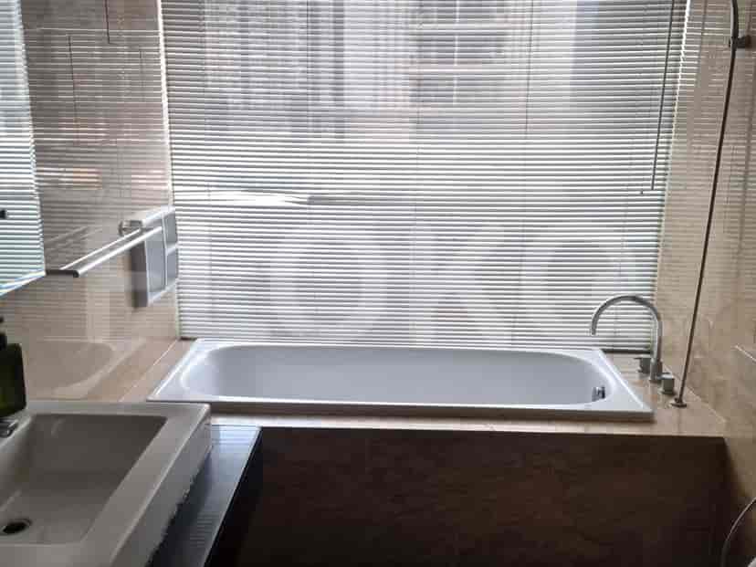 Bathroom with a bathtub and blinds.