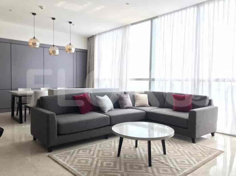A luxurious living space with an L-shaped sofa, marble coffee table, and pendant lights.