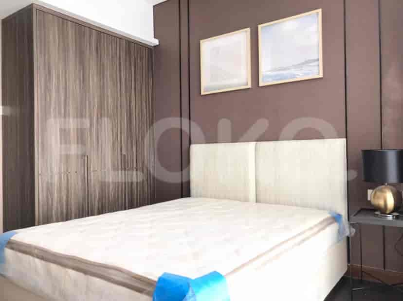 Elegant bedroom with a king-size bed, framed artwork, and a large wardrobe.