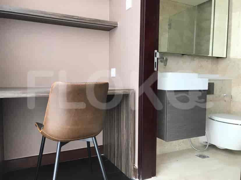 A combination home office and a bathroom featuring a desk, chair, and modern bathroom fixtures.