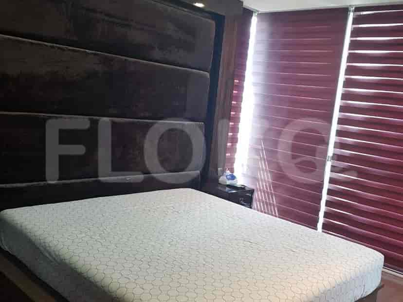 A bedroom with a bed, a nightstand, and blinds.