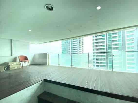 A spacious balcony with a view of the city.