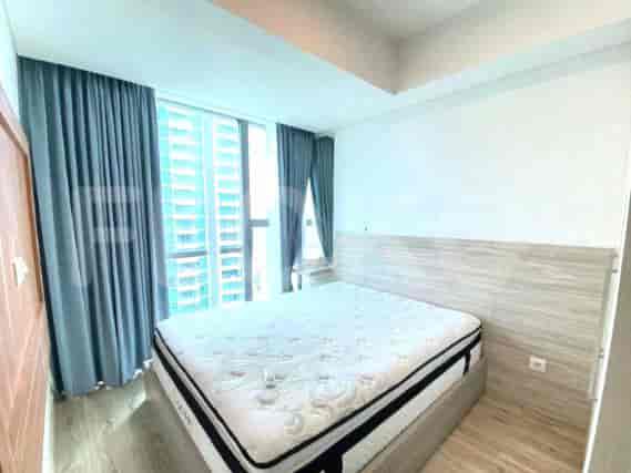 Bedroom with a large bed and dark curtains.