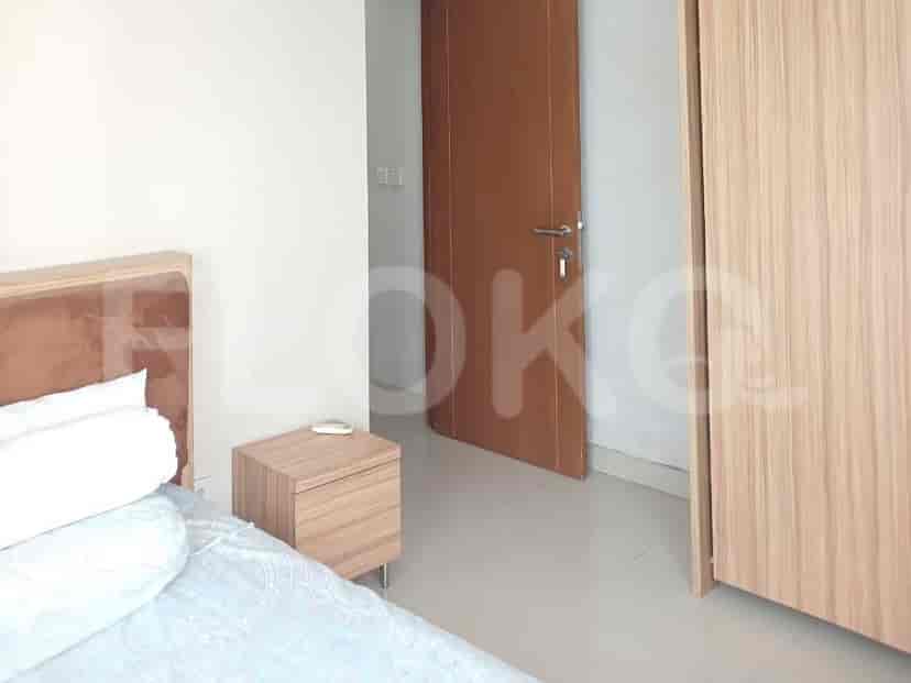 Bedroom with a bed, bedside table, and closet.