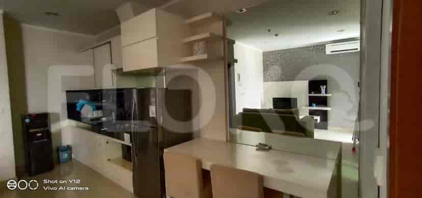 An open kitchen and living space, with dining table, kitchen, and sofa.