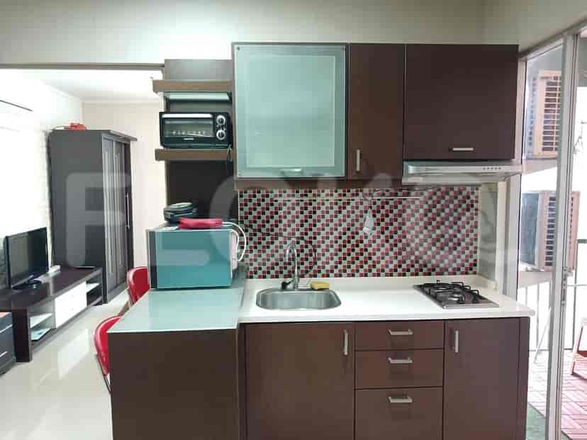 Kitchenette area with appliances and cabinets.