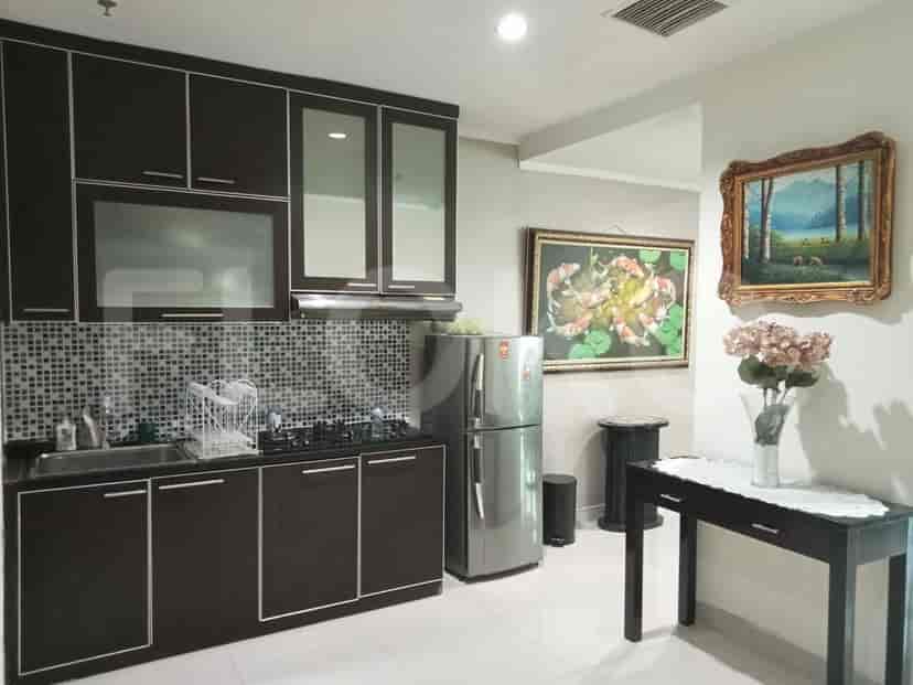 Modern kitchen with dark cabinetry and stainless steel appliances.