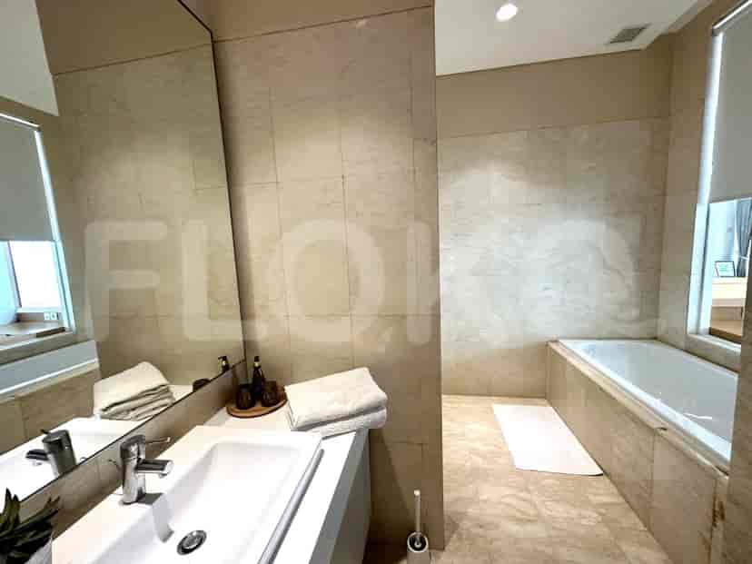 A spacious bathroom with a bathtub, a sink, and a large mirror.