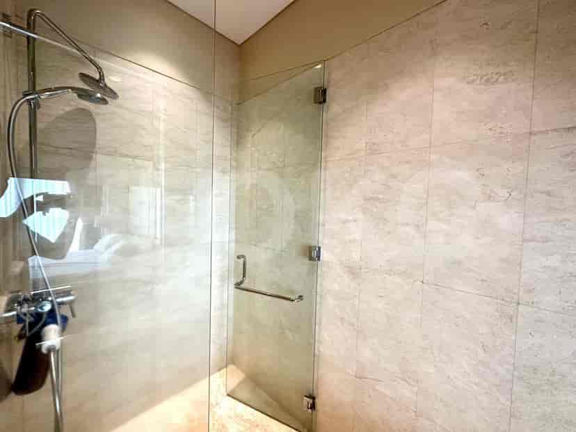A modern shower with a glass door.