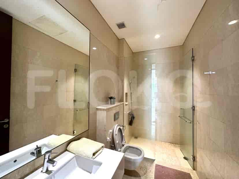 A bathroom with a sink, a shower, and a toilet.