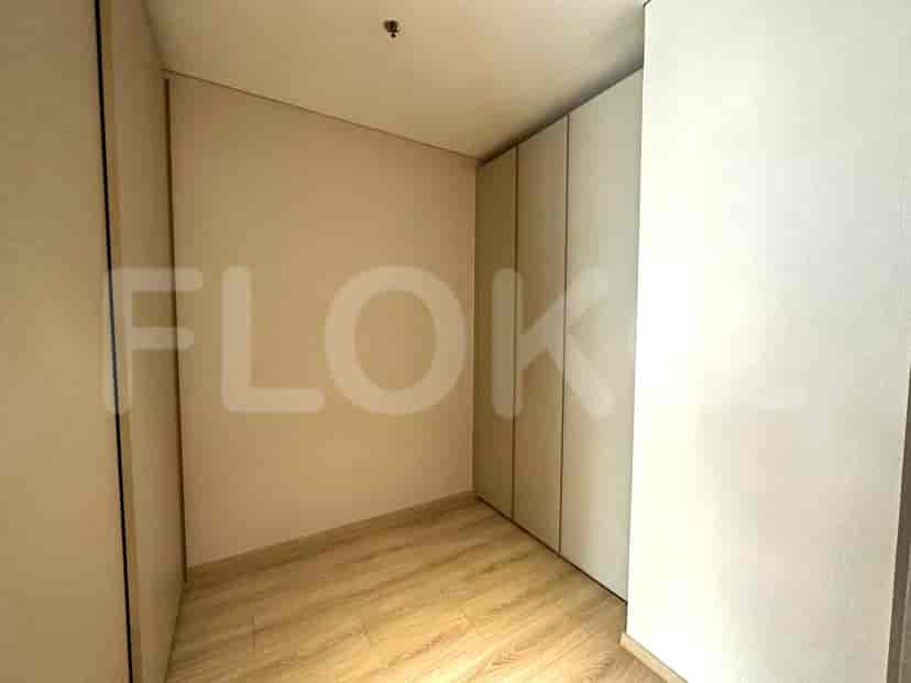 An empty closet with white doors.