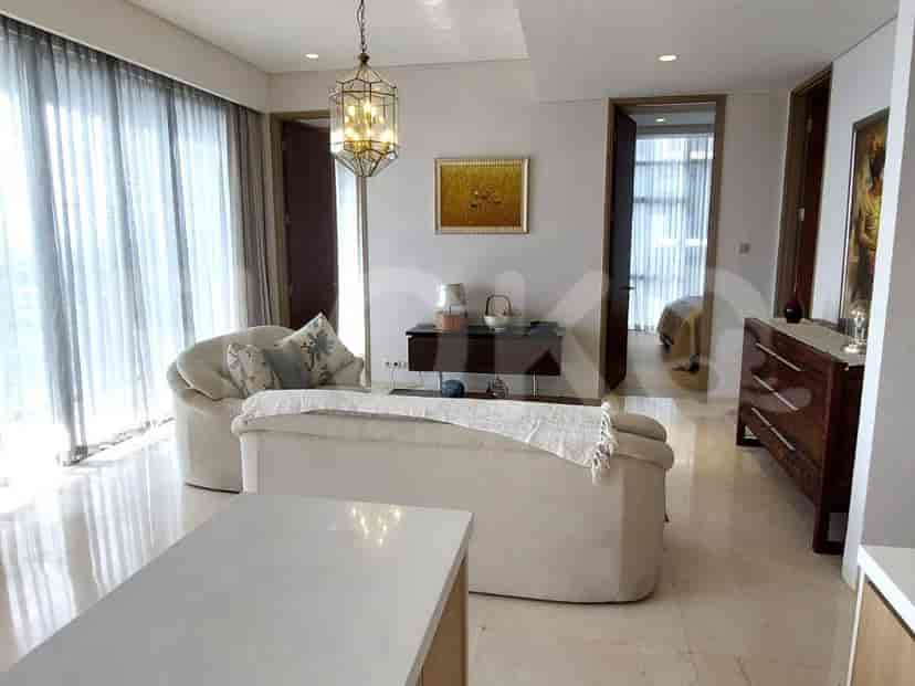 Living room with sofa and a kitchen.