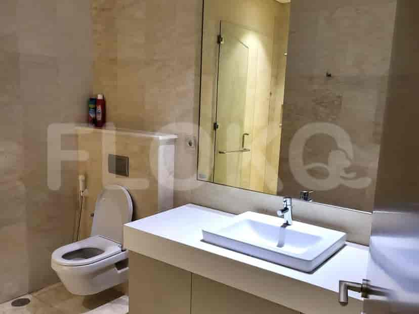 Bathroom with a toilet, sink, and shower.